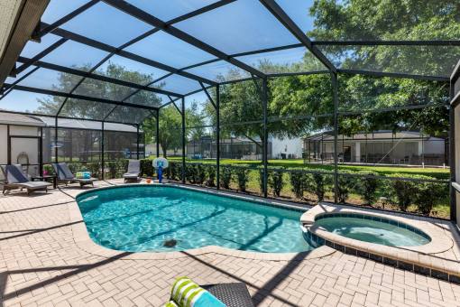 Villa By The Castle's private saline Pool and spa and lounge chairs - A luxury 6 bedroom kissimmee vacation villa rental