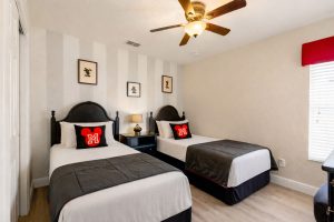 The Mickey room features two twin beds, a ceiling fan, 32 inch HD LED TV with internet apps, a chair that converts to an extra twin bed, and large double door closets.