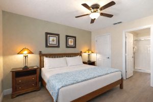 The King Bedroom features a king sized pillow top mattress, ceiling fan, 32 inch HD TV with Internet Apps, accent chair and an en suite with walk-in shower